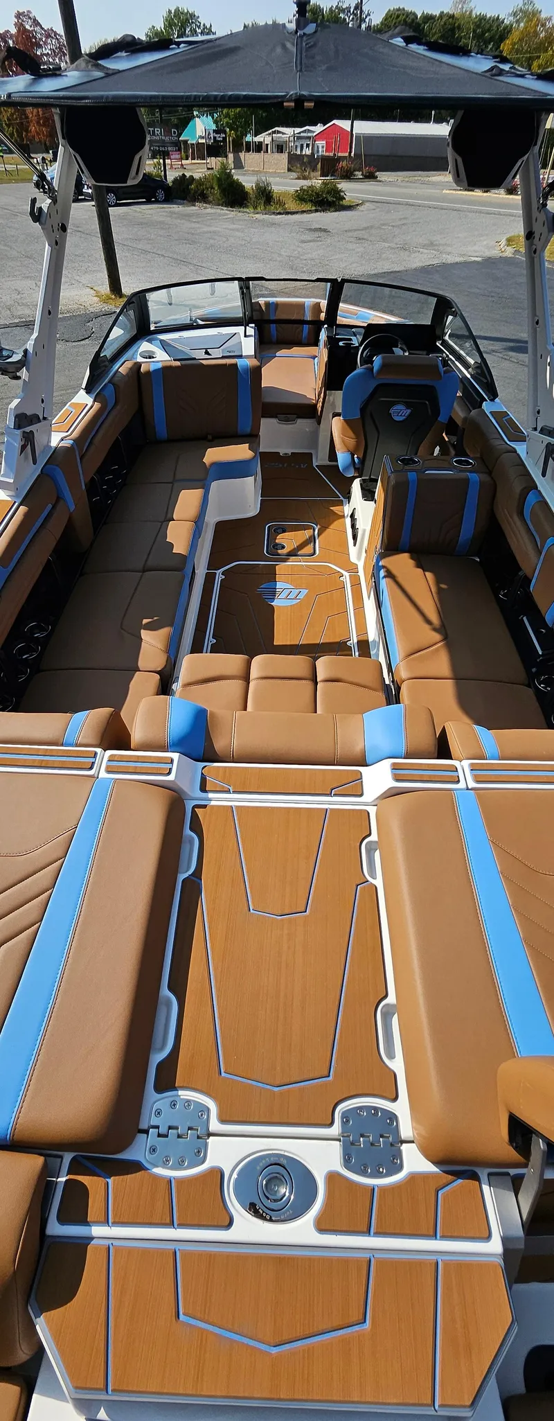 Slide: The Image of 2025 Malibu 25LSV boat interior with tan and blue seating, sleek design. - 12