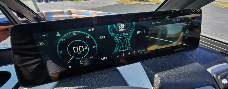 Slide: The Image of 2025 Malibu 25LSV dashboard display with digital speedometer and rear camera view. - 21