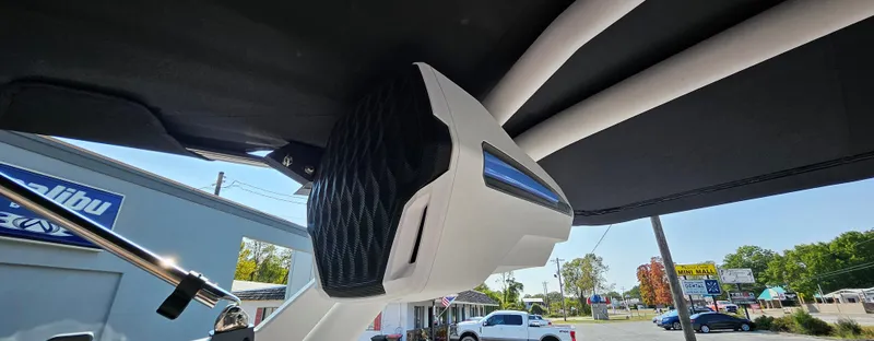 Slide: The Image of 2025 Malibu 25LSV boat speaker system under canopy, outdoor setting. - 22
