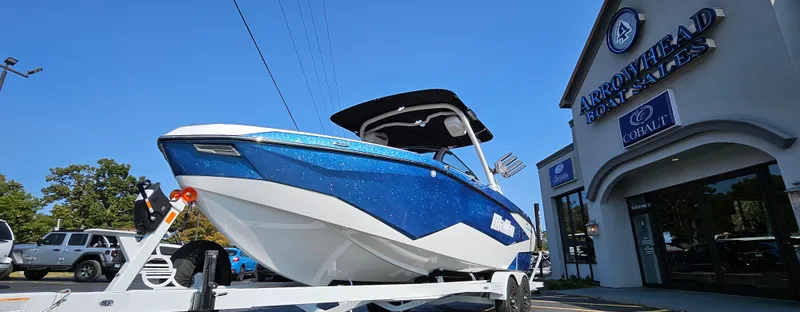 Slide: The Image of 2025 Malibu 25LSV boat on trailer at Arrowhead Boat Sales dealership. - 3