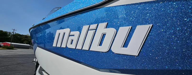 Slide: The Image of 2025 Malibu 25LSV boat with sparkling blue exterior and bold logo. - 5