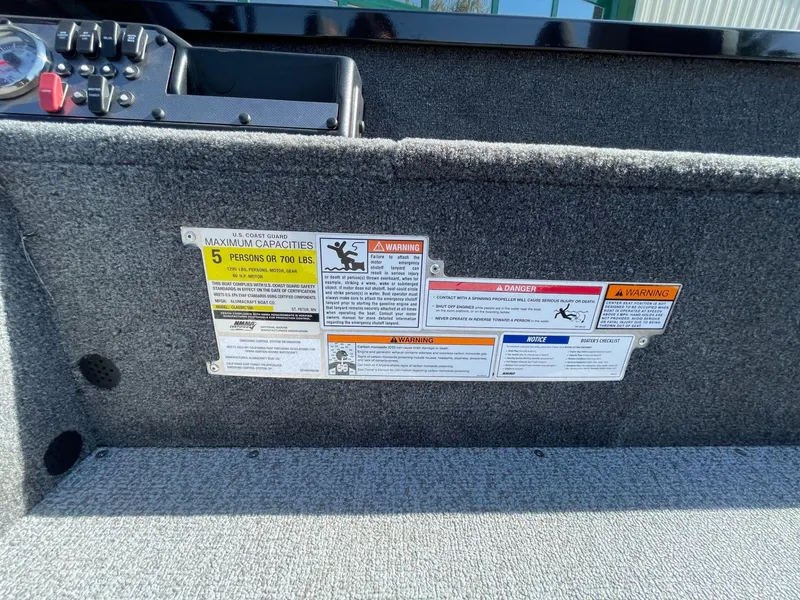 Slide: The Image of Safety labels on 2024 Alumacraft Classic 165 Tiller boat interior. - 10
