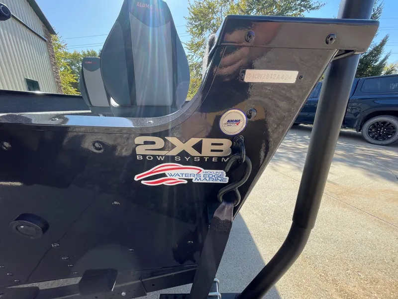 Slide: The Image of 2024 Alumacraft Classic 165 Tiller boat with 2XB Bow System branding. - 4