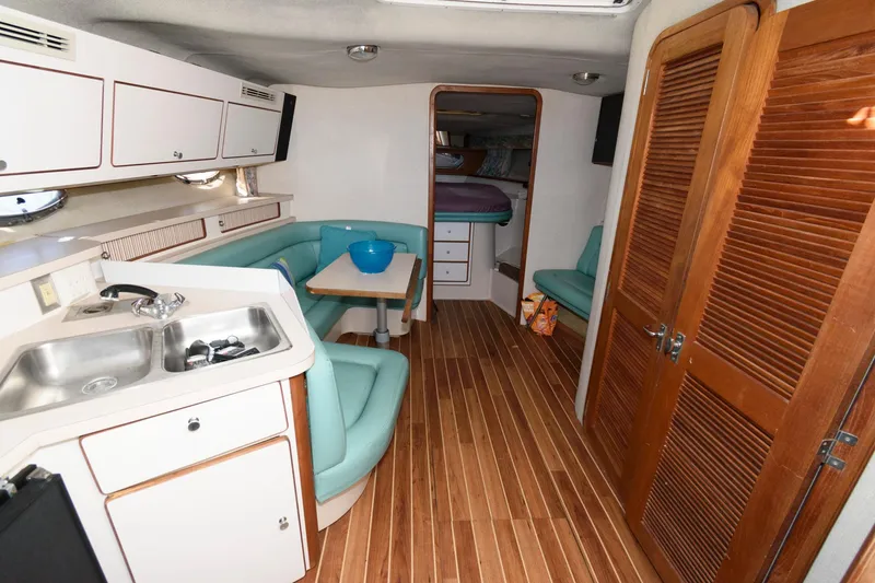 Slide: The Image of Interior of 1992 Regal Commodore 402 yacht with kitchen and seating area. - 10