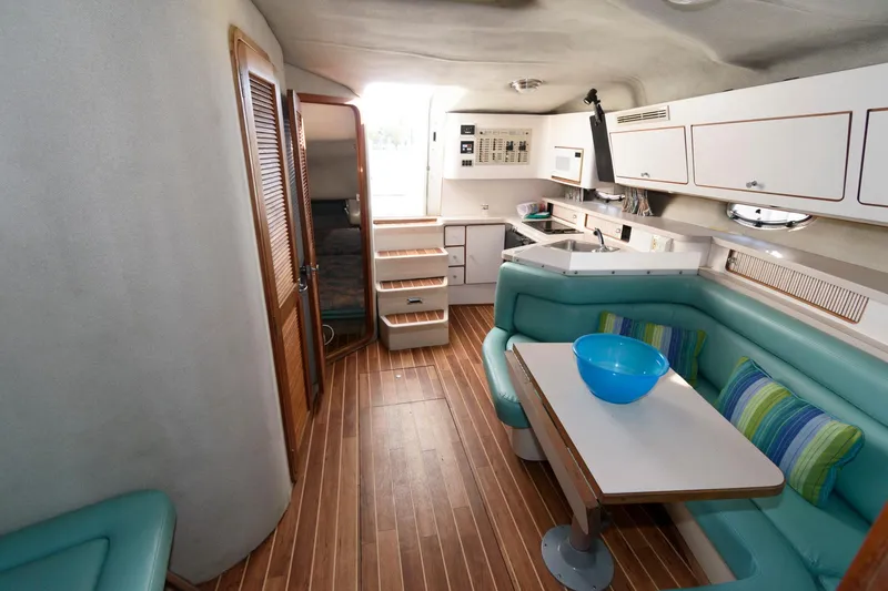 Slide: The Image of Interior of 1992 Regal Commodore 402 yacht with modern kitchen and seating area. - 12