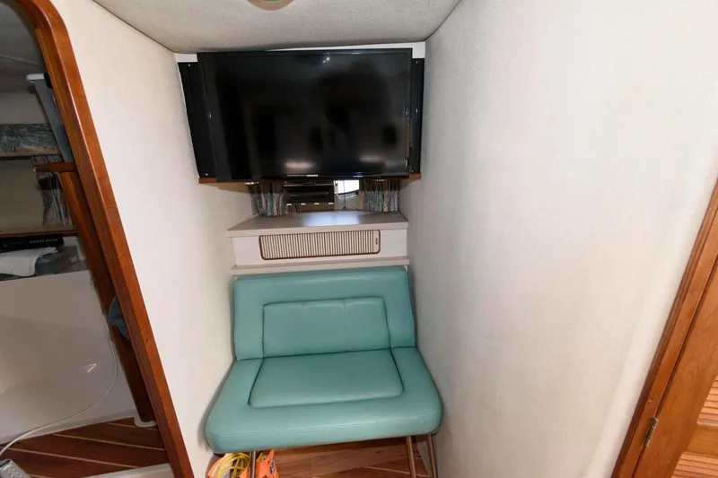 Slide: The Image of 1992 Regal Commodore 402 interior with TV and teal seating. - 13