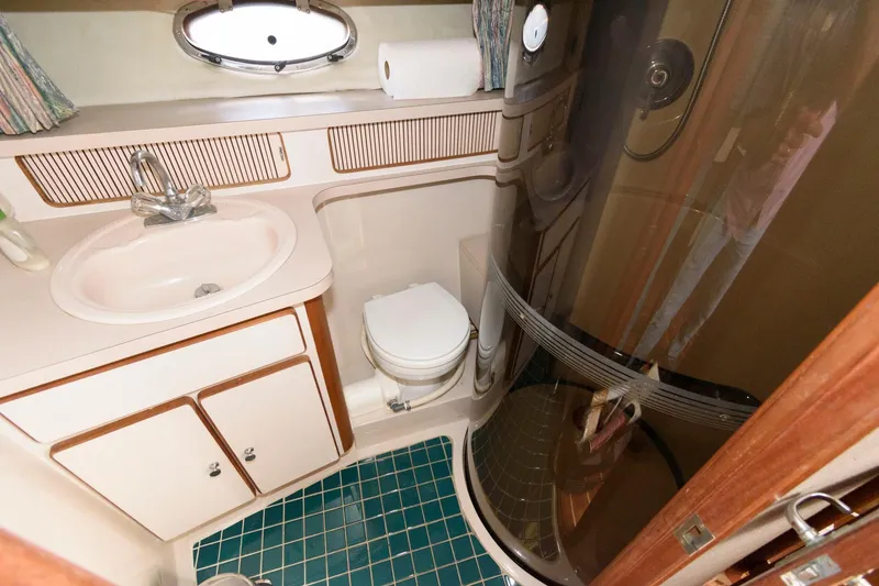 Slide: The Image of 1992 Regal Commodore 402 bathroom with sink, toilet, and shower. - 17