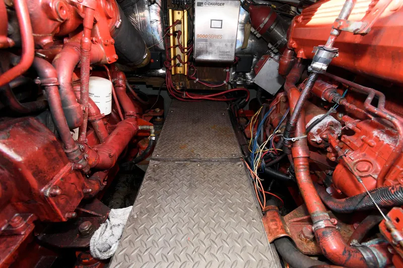 Slide: The Image of Engine room of 1992 Regal Commodore 402 with red machinery and metal walkway. - 18