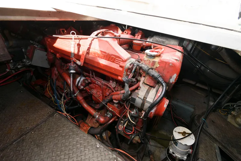 Slide: The Image of Engine compartment of 1992 Regal Commodore 402 boat, featuring a red engine. - 19