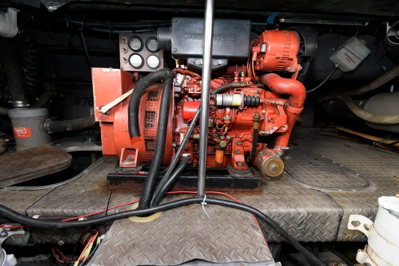 Slide: The Image of Engine room of 1992 Regal Commodore 402 with red machinery and control panel. - 21