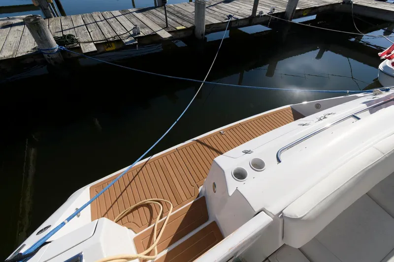 Slide: The Image of 1992 Regal Commodore 402 boat docked, featuring teak deck and white seating. - 3