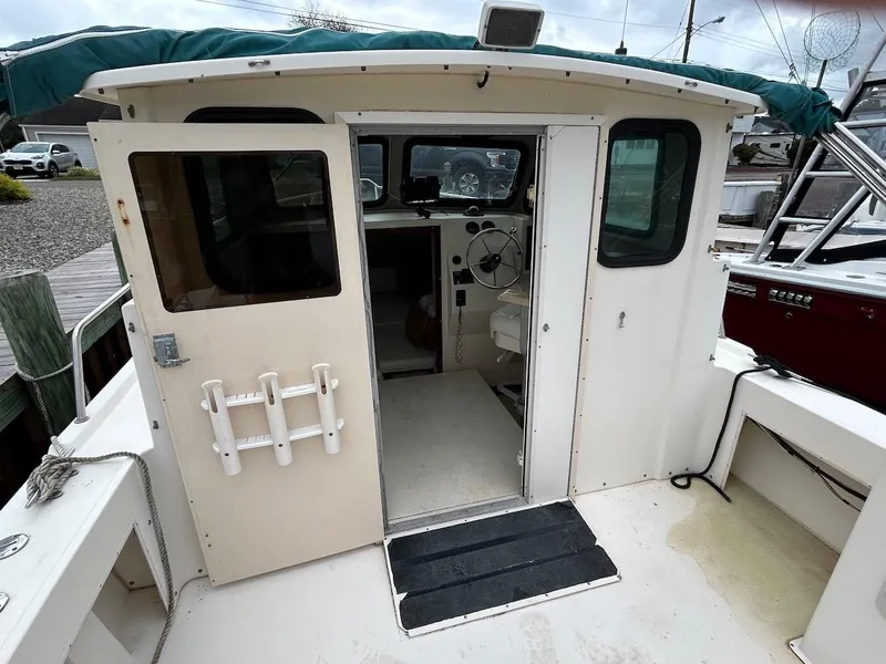 Slide: The Image of 2001 Parker 2520 Modified Vee Sport Cabin boat interior with open cabin door. - 11