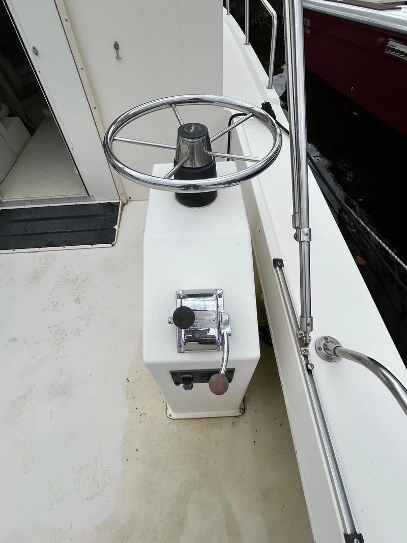 Slide: The Image of 2001 Parker 2520 Modified Vee Sport Cabin helm with steering wheel and controls. - 12