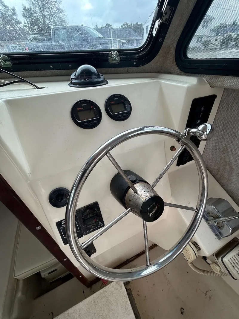 Slide: The Image of 2001 Parker 2520 Modified Vee Sport Cabin helm with steering wheel and instrument panel. - 18