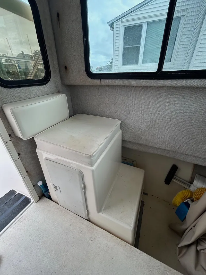 Slide: The Image of Interior of 2001 Parker 2520 Modified Vee Sport Cabin boat with seating and storage. - 19