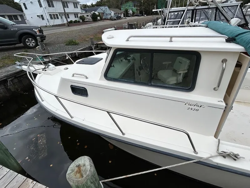 Slide: The Image of 2001 Parker 2520 Modified Vee Sport Cabin boat docked at marina. - 2