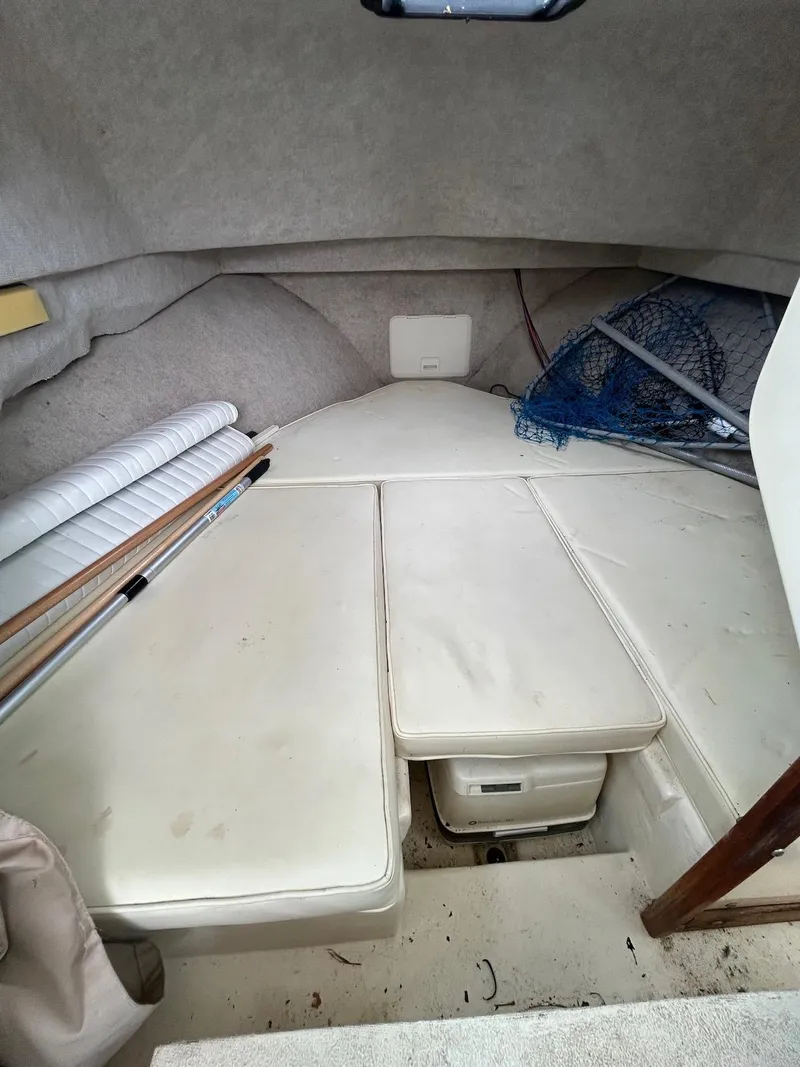 Slide: The Image of 2001 Parker 2520 Modified Vee Sport Cabin interior with cushioned seating and storage. - 21