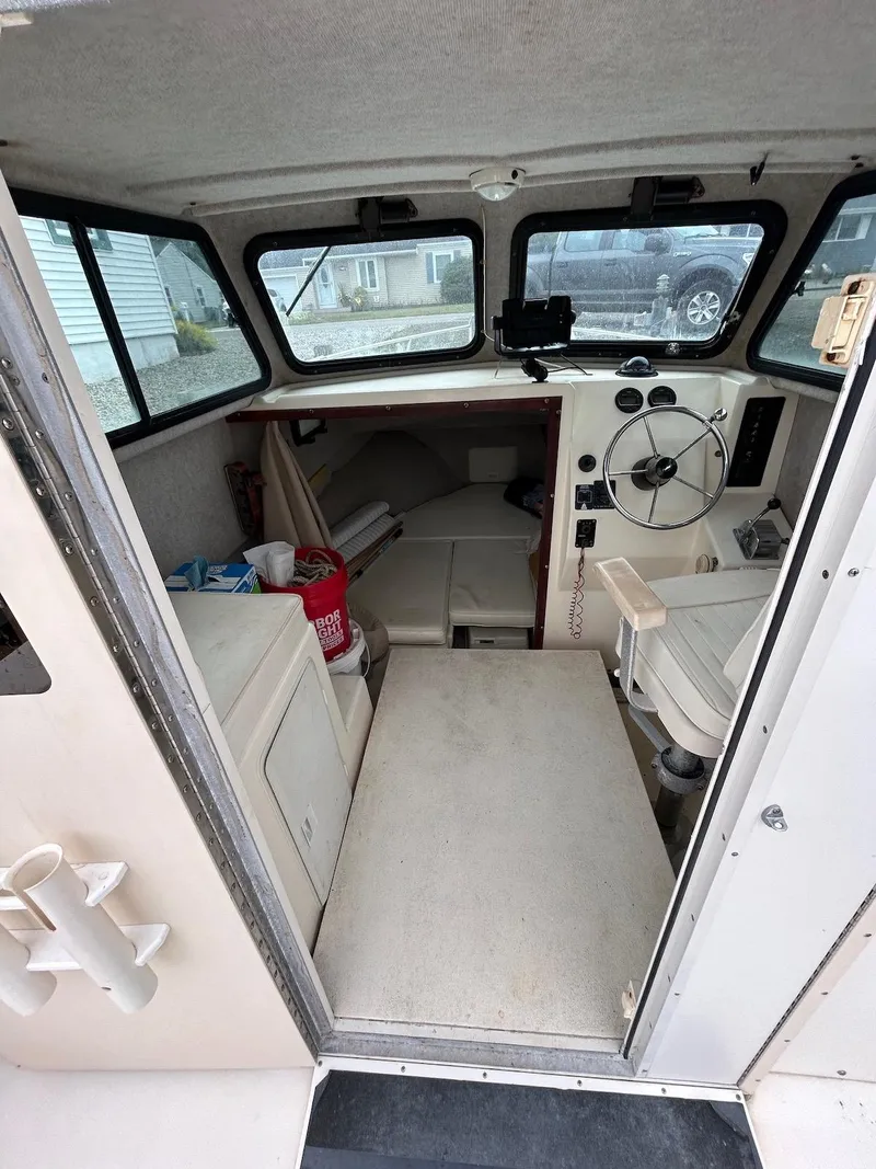 Slide: The Image of 2001 Parker 2520 Modified Vee Sport Cabin interior with steering wheel and seating. - 23