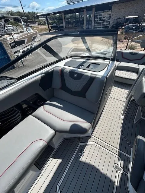 Slide: The Image of 2022 Nautique G23 boat interior with gray seating and modern design. - 13