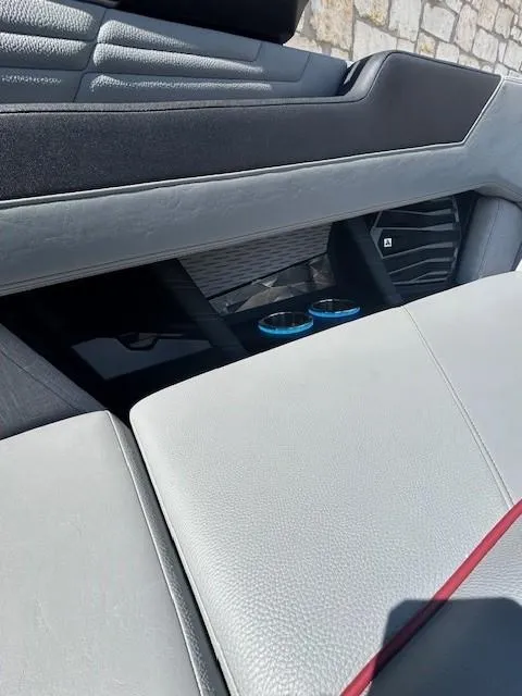 Slide: The Image of 2022 Nautique G23 interior with sleek seating and cup holders. - 14