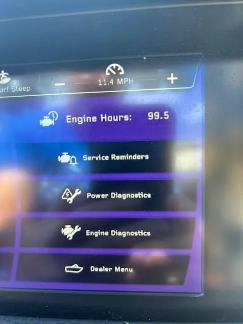 Slide: The Image of Dashboard of 2022 Nautique G23 showing engine hours and diagnostics menu. - 16