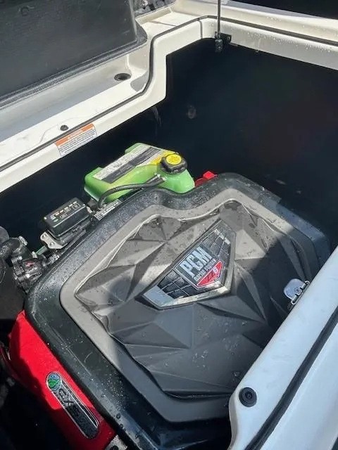 Slide: The Image of Engine compartment of 2022 Nautique G23 boat, featuring PCM engine components. - 19