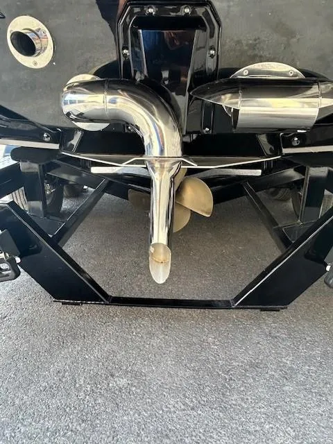 Slide: The Image of 2022 Nautique G23 boat propeller and exhaust system close-up. - 22