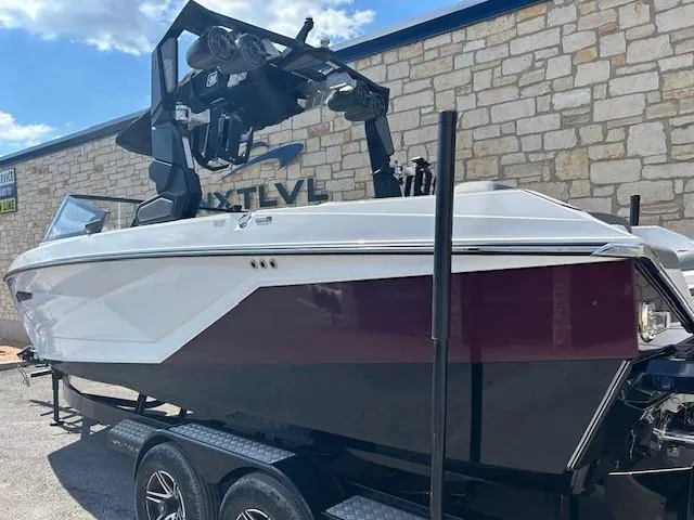 Slide: The Image of 2022 Nautique G23 boat on trailer, featuring sleek design and modern wakeboard tower. - 3