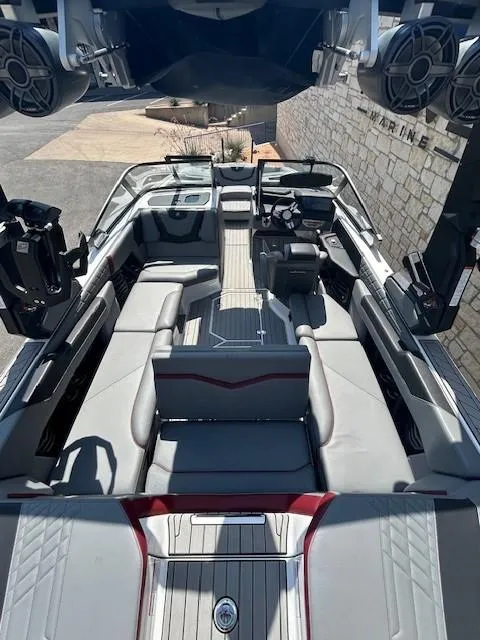 Slide: The Image of 2022 Nautique G23 boat interior with sleek seating and advanced audio system. - 6