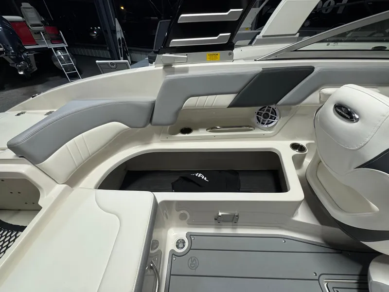 Slide: The Image of 2024 Chaparral 23 SSi OB boat interior with storage compartment and seating. - 11
