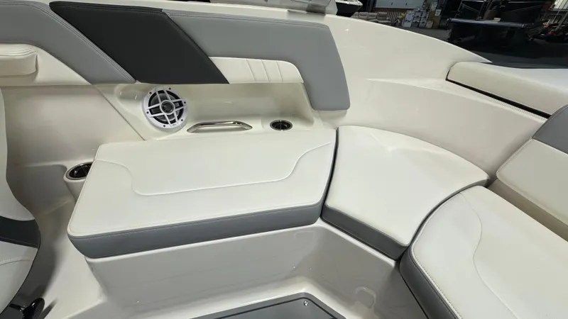 Slide: The Image of 2024 Chaparral 23 SSi OB boat interior with white and gray seating. - 12