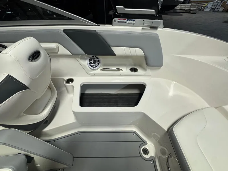 Slide: The Image of 2024 Chaparral 23 SSi OB boat interior with seating and storage compartment. - 13