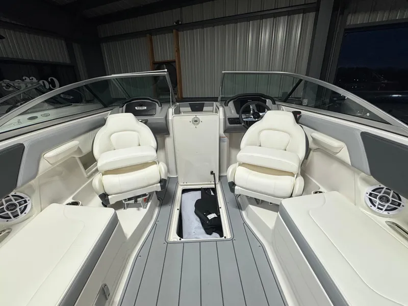Slide: The Image of 2024 Chaparral 23 SSi OB boat interior with white seating and modern dashboard. - 15