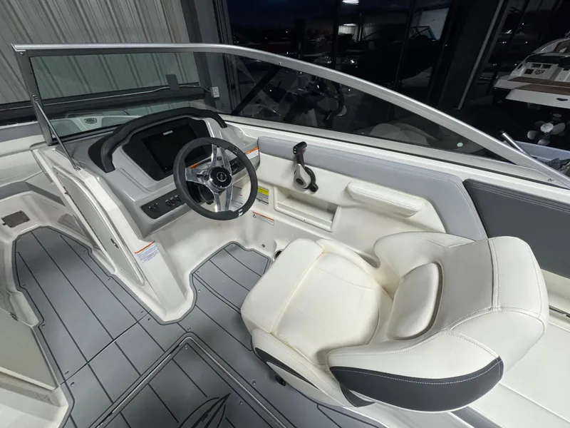 Slide: The Image of 2024 Chaparral 23 SSi OB boat interior with steering wheel and seating. - 17