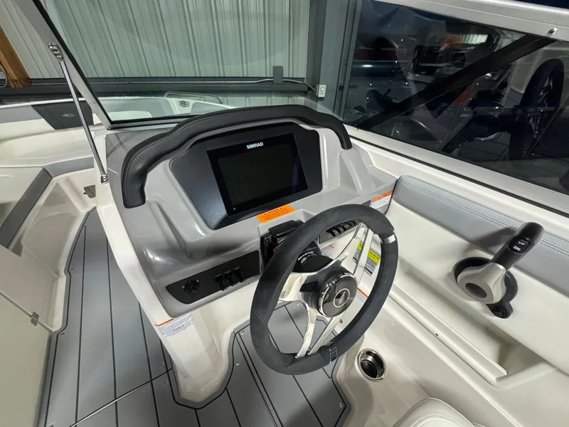 Slide: The Image of 2024 Chaparral 23 SSi OB boat dashboard with steering wheel and digital display. - 18
