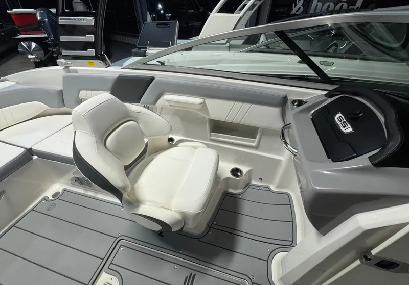 Slide: The Image of 2024 Chaparral 23 SSi OB boat interior with white seating and modern dashboard. - 21