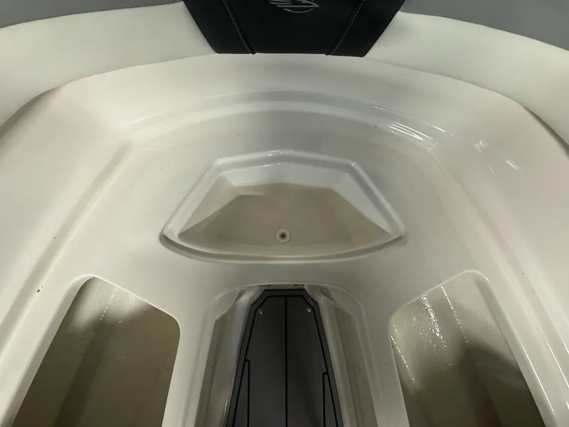Slide: The Image of 2024 Chaparral 23 SSi OB boat interior, featuring sleek white seating and storage compartments. - 26