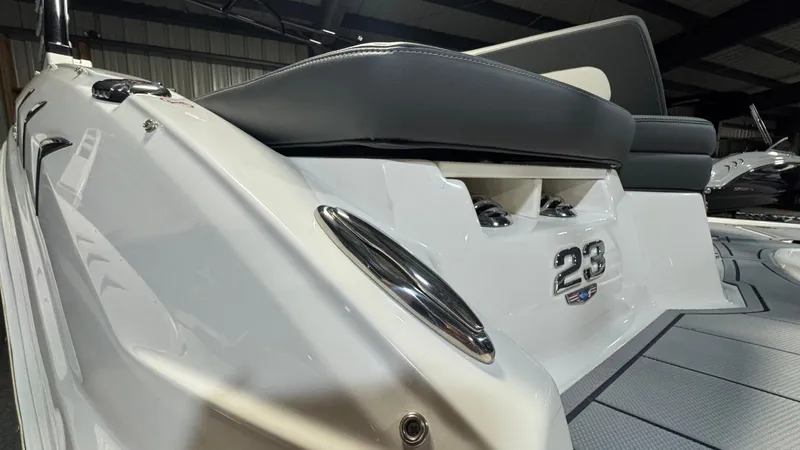 Slide: The Image of 2024 Chaparral 23 SSi OB boat, sleek white design, close-up view. - 29