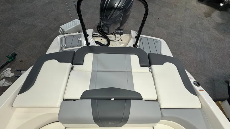 Slide: The Image of 2024 Chaparral 23 SSi OB boat with cushioned seating and outboard motor. - 4