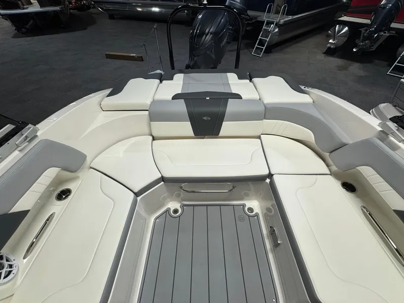 Slide: The Image of 2024 Chaparral 23 SSi OB boat interior with cushioned seating and sleek design. - 8