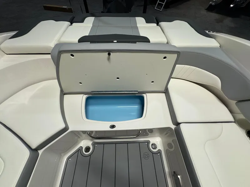 Slide: The Image of 2024 Chaparral 23 SSi OB boat interior with open storage compartment. - 9