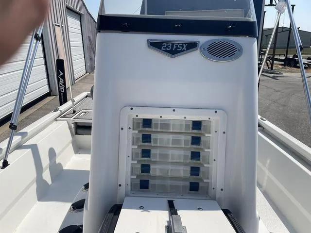 Slide: The Image of 2024 Avid 23 FSX boat interior with storage compartments and console. - 13