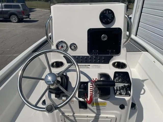 Slide: The Image of 2024 Avid 23 FSX boat console with steering wheel and gauges. - 15