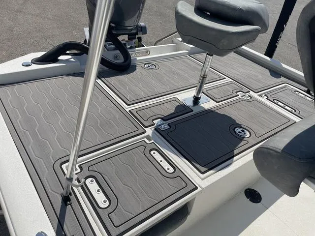 Slide: The Image of 2024 Avid 23 FSX boat deck with gray non-slip surface and seating. - 18