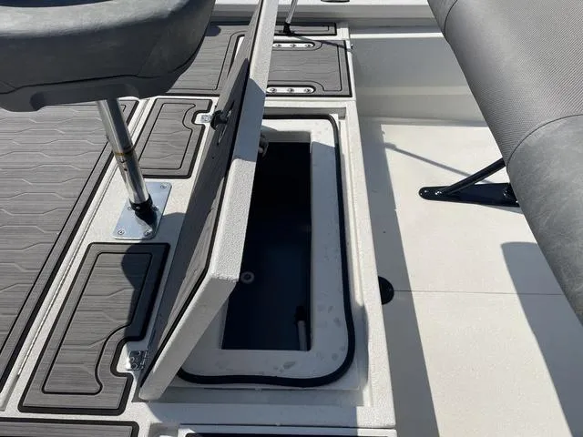 Slide: The Image of 2024 Avid 23 FSX boat interior with open storage compartment. - 20
