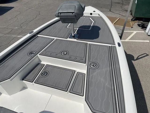 Slide: The Image of 2024 Avid 23 FSX boat deck with gray non-slip surface and seating. - 6