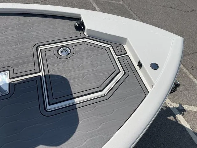Slide: The Image of 2024 Avid 23 FSX boat deck with sleek design and storage compartment. - 7
