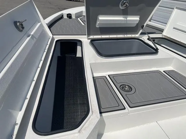 Slide: The Image of 2024 Avid 23 FSX boat storage compartments and deck details. - 9