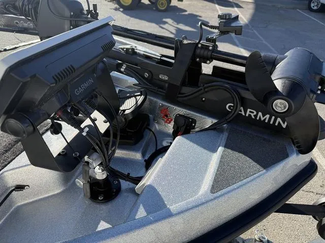 Slide: The Image of 2024 Bass Cat Puma STS boat deck with gray carpet and storage compartments. - 10