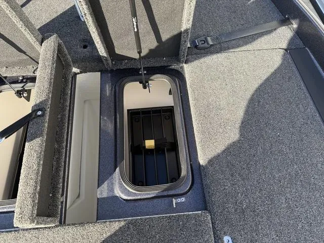 Slide: The Image of 2024 Bass Cat Puma STS storage compartment with open lid, showcasing interior space. - 12